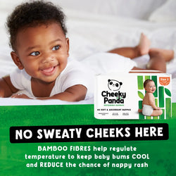Baby lying on a white blanket with Cheeky Panda bamboo diapers packaging displayed.