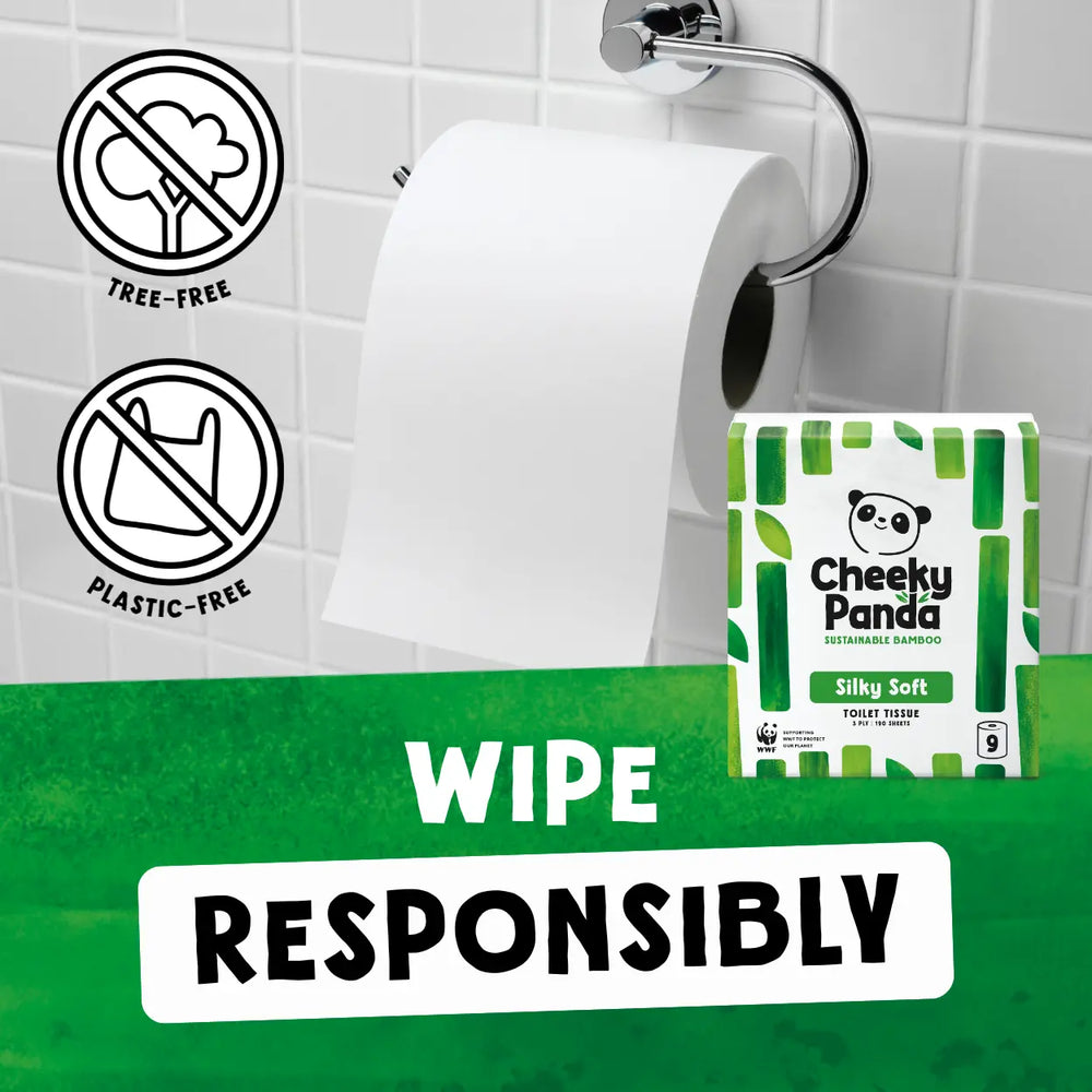 Cheeky Panda Silky Soft toilet paper packaging with a roll of toilet paper on a holder against a tiled bathroom wall.