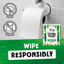 Cheeky Panda Silky Soft toilet paper packaging with a roll of toilet paper on a holder against a tiled bathroom wall.