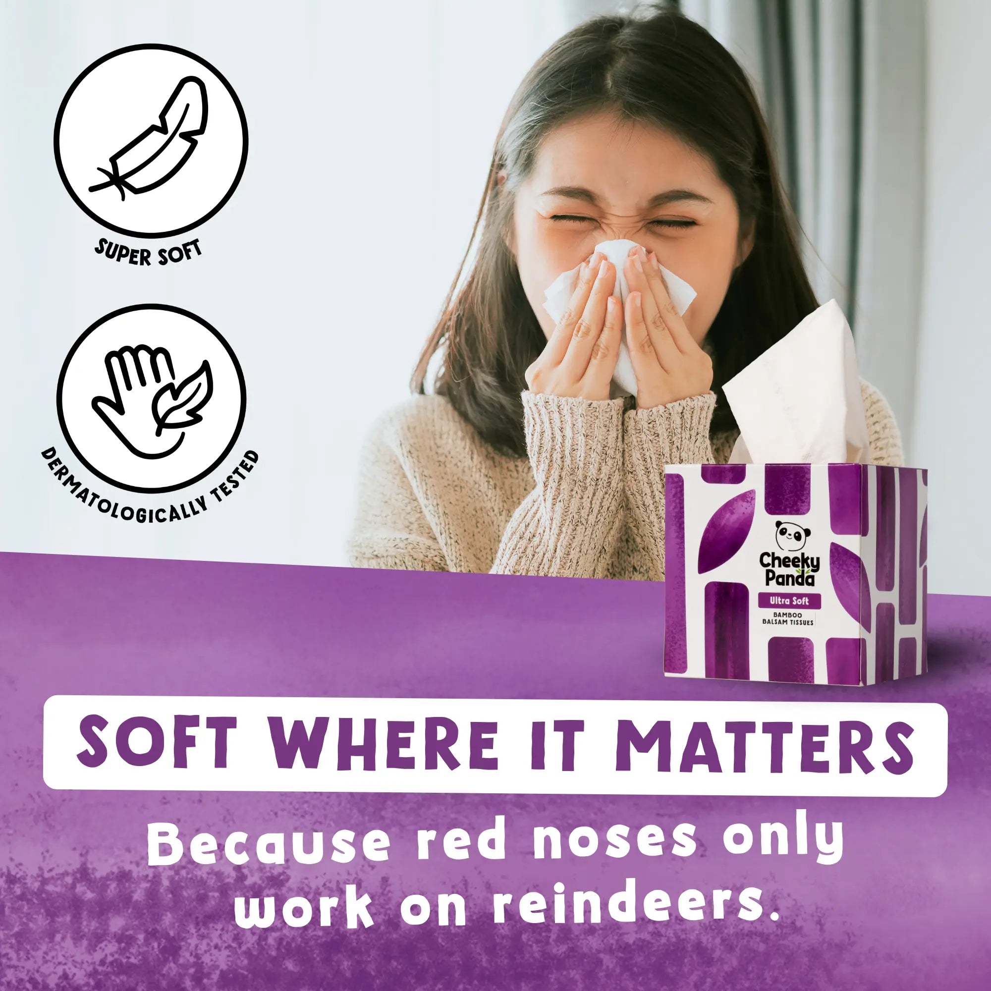 A woman gently blowing her nose with a Cheeky Panda tissue, with a purple tissue box nearby.