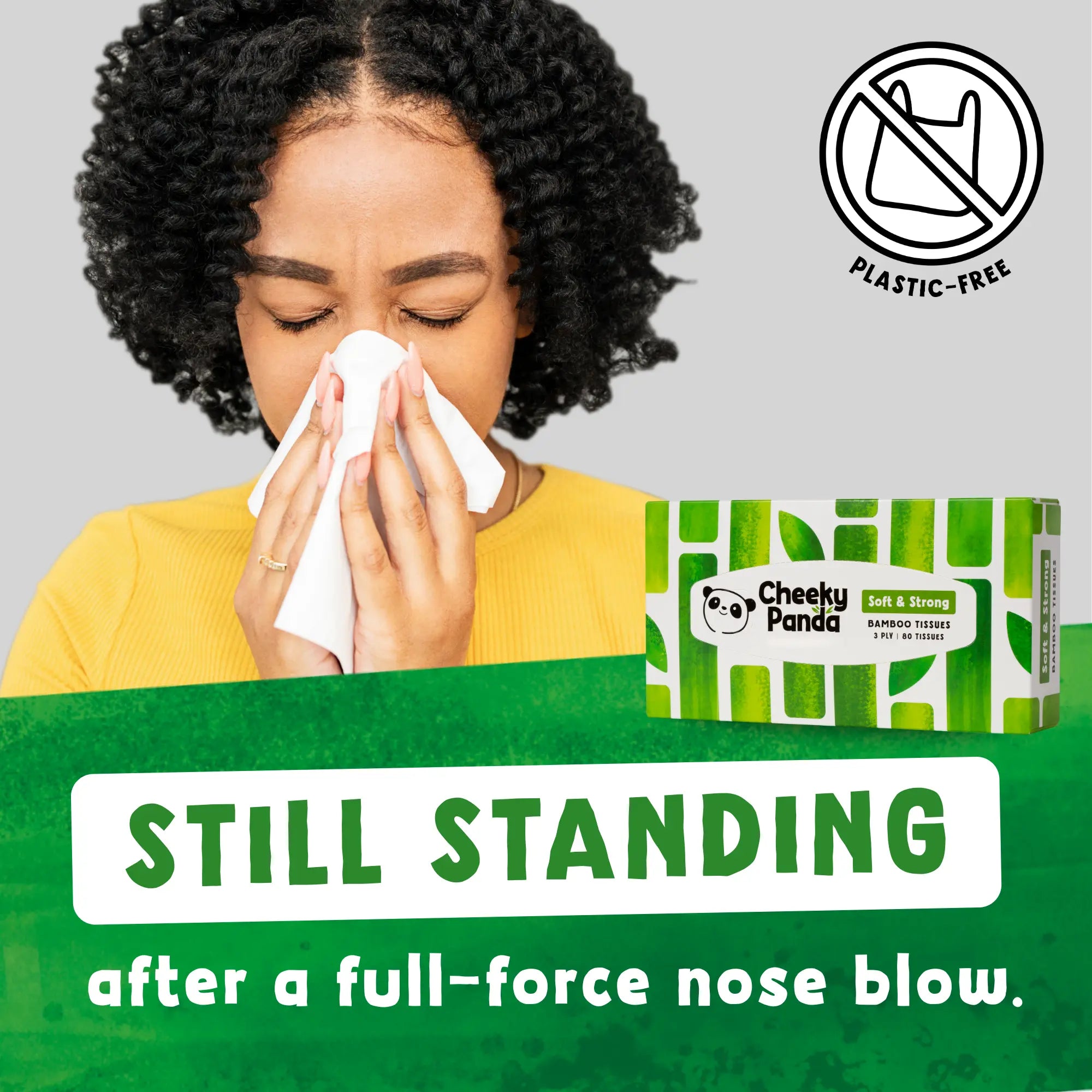 Woman blowing her nose with a Cheeky Panda tissue, text: 'Still standing'.