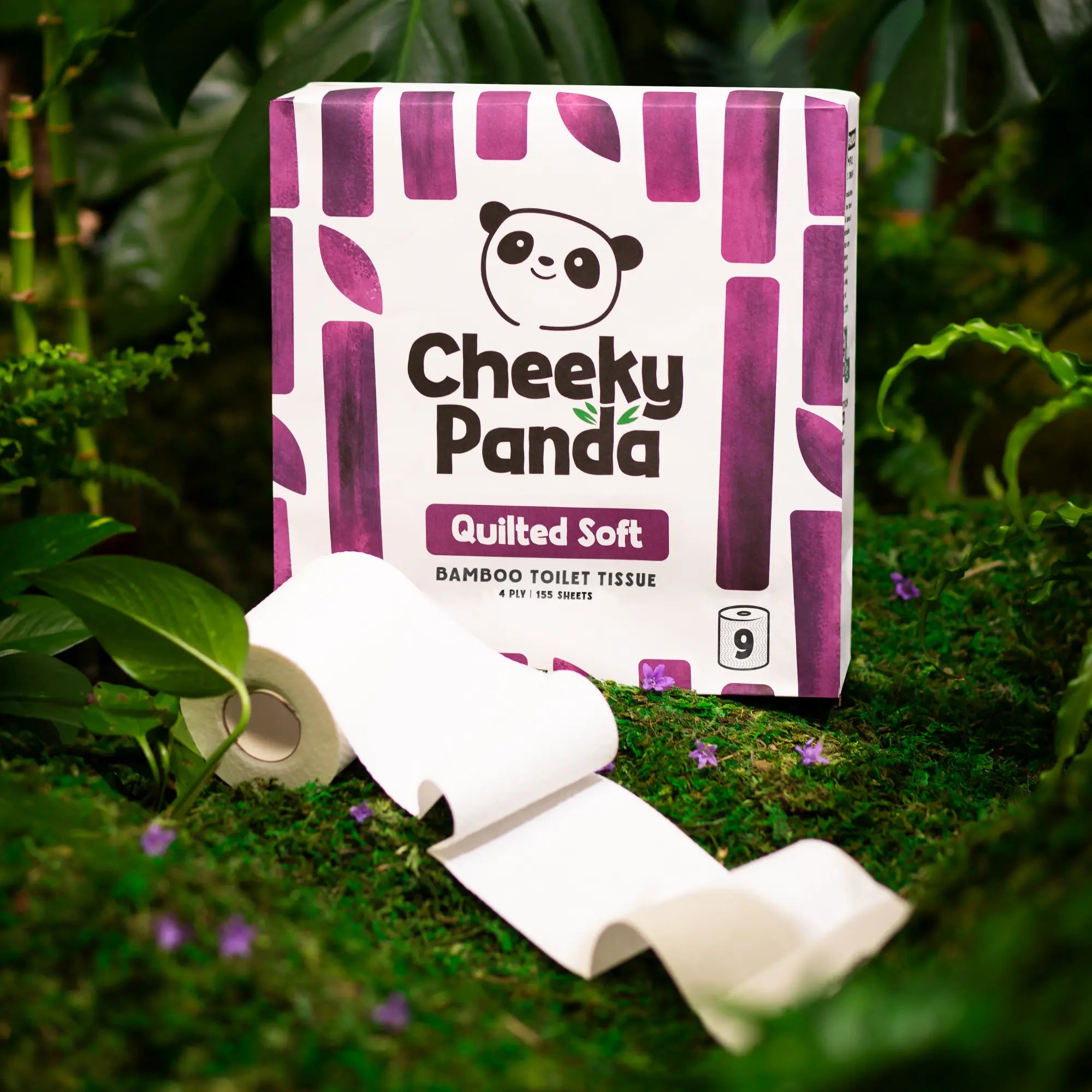 Cheeky Panda Quilted Soft bamboo toilet tissue 9-roll pack with a roll unravelling on moss.