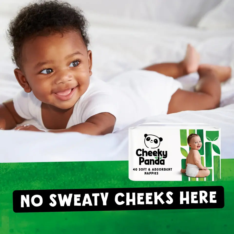 A smiling baby on a white blanket, with a pack of Cheeky Panda nappies visible.